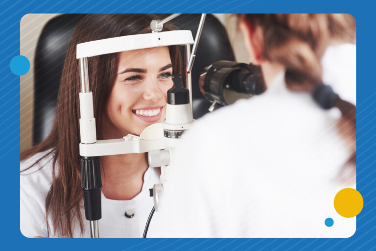 A woman smiles as she gets her eyes checked by an optometrist using special equipment. Dr. Sam Dhaliwal & Associates is ready to help you schedule your eye exam to beat the rush.